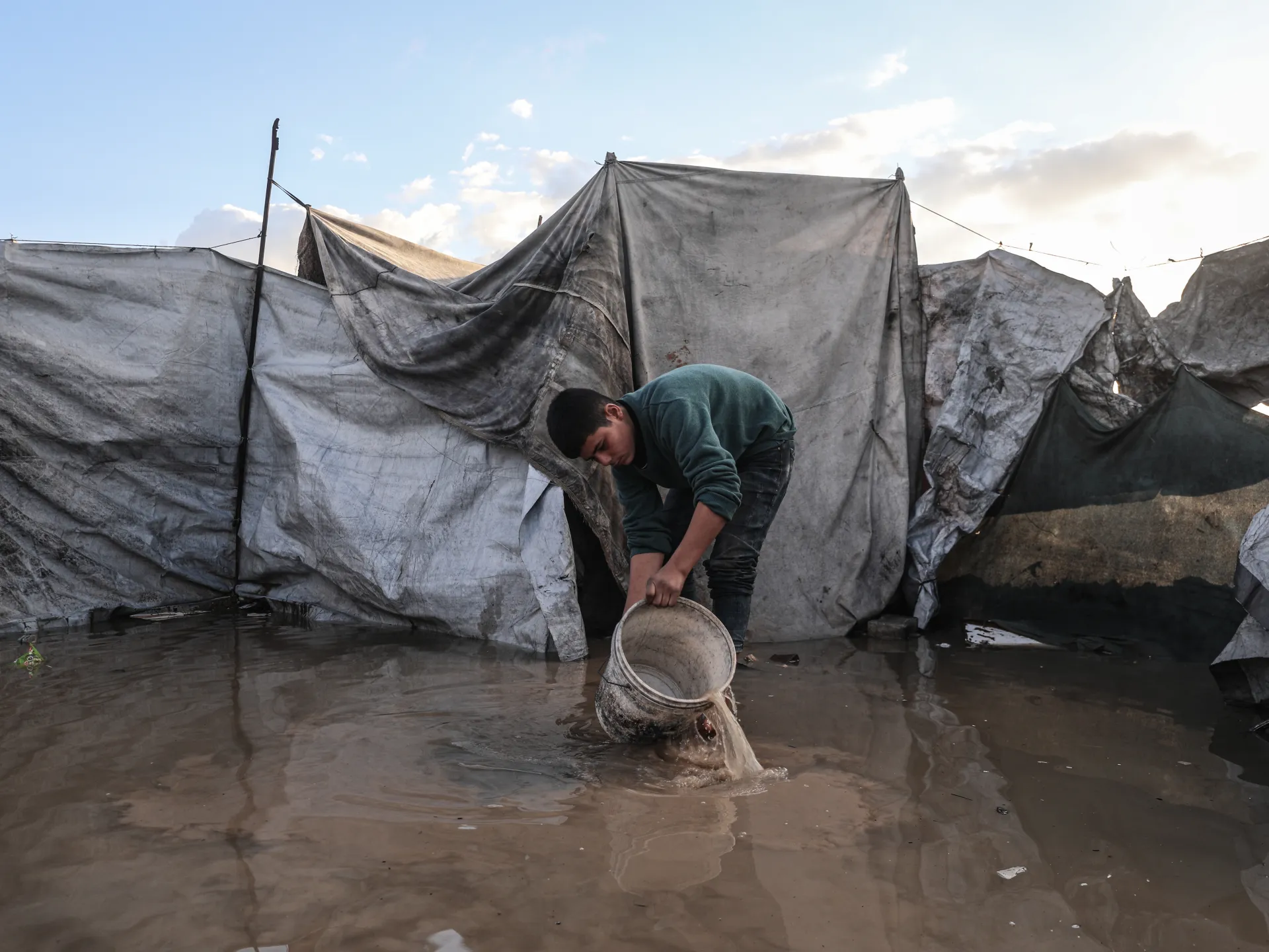 Palestinians Struggle with Flooded Tents and Debris Amid Cold, Rain in Gaza