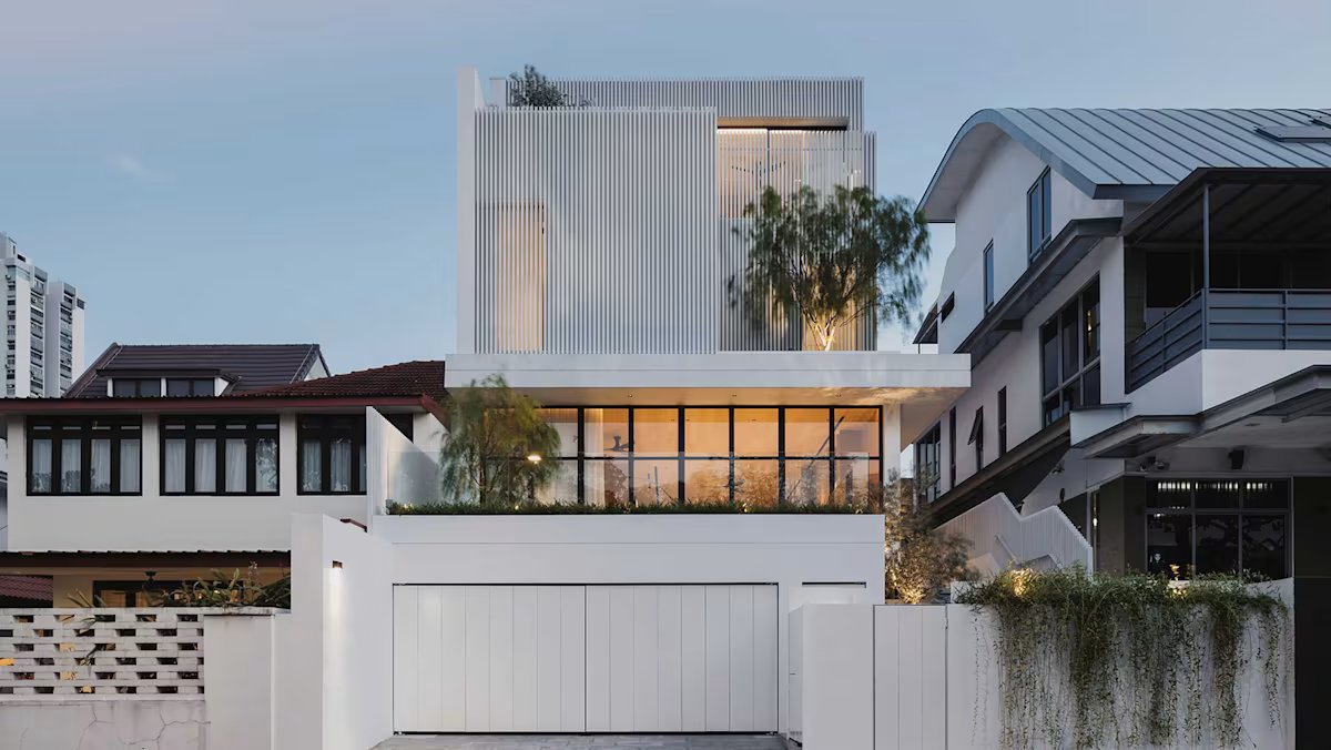 Beneath the enigmatic white exterior of this Singapore semi-detached house is a cozy, sunny sanctuary.